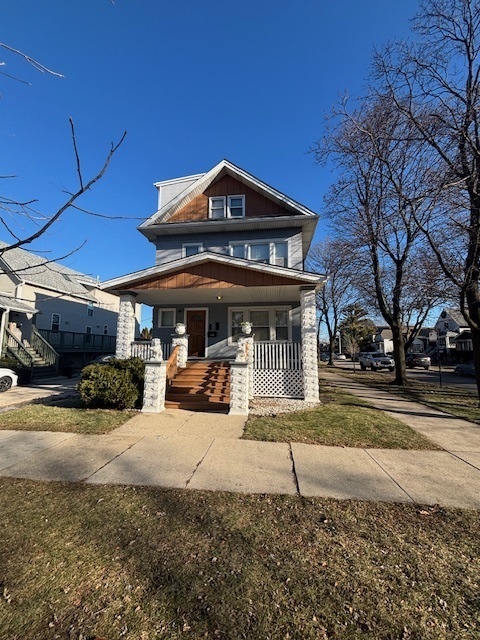 a view of a house with a yard next to a road