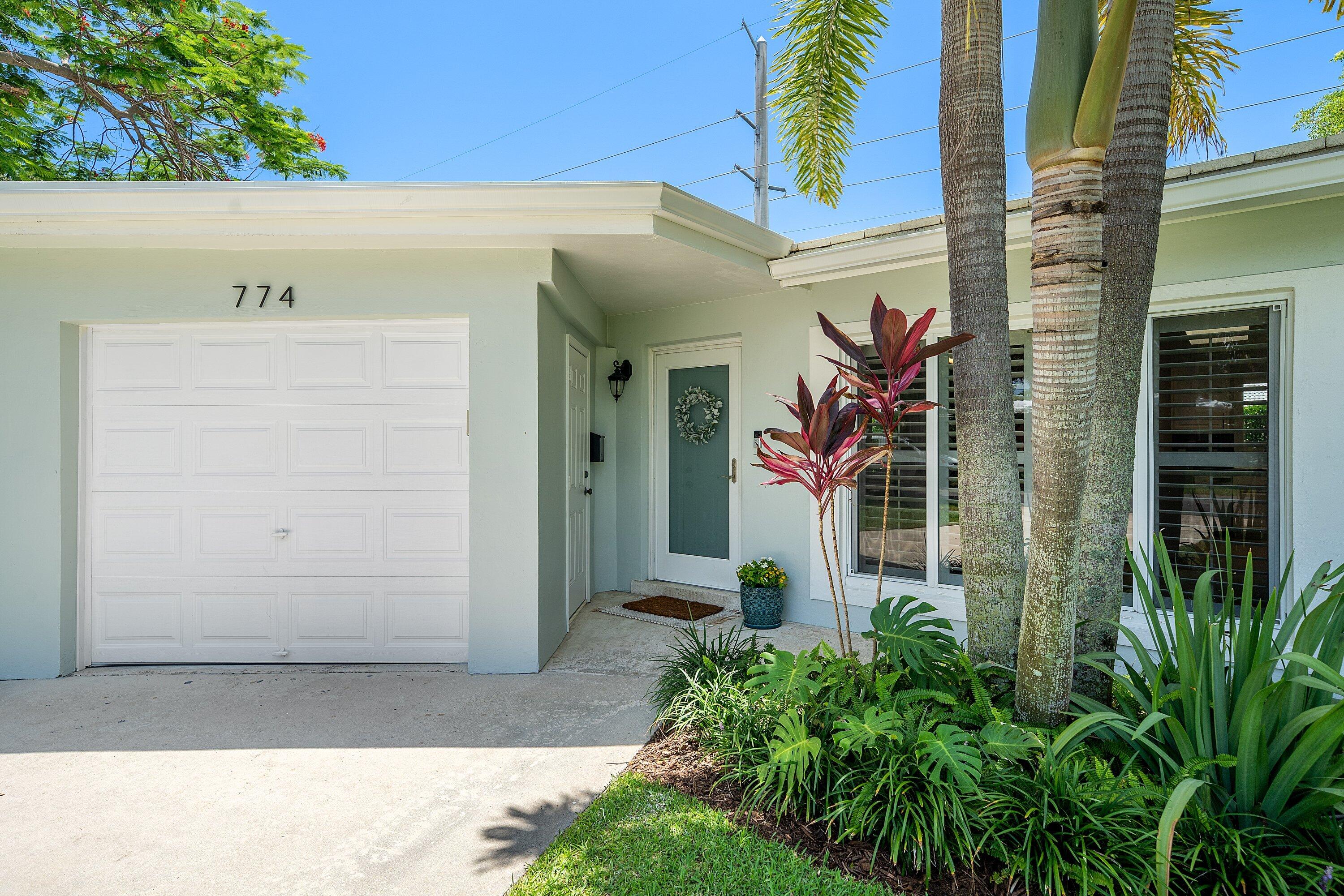 774 Southwest 7th Street Boca Raton, FL 33486 - Photo 3 of 28 a front view of a house with a yard