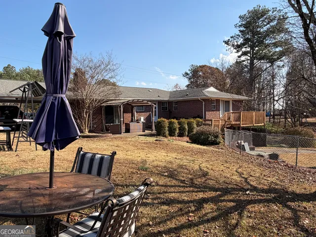 a view of a backyard with sitting area