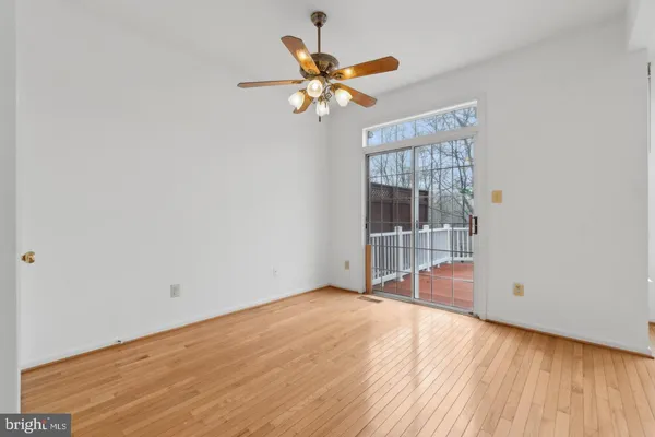 a view of a livingroom with a ceiling fan and wooden floor