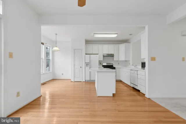 a view of kitchen with white cabinets