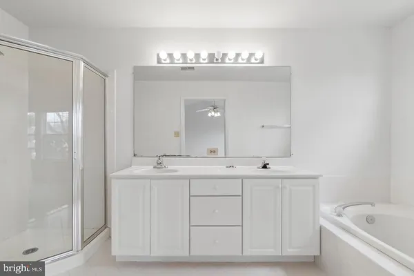 a spacious bathroom with a granite countertop sink a toilet and shower