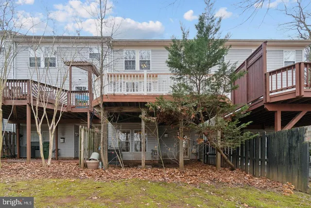 a balcony with wooden floor and fence