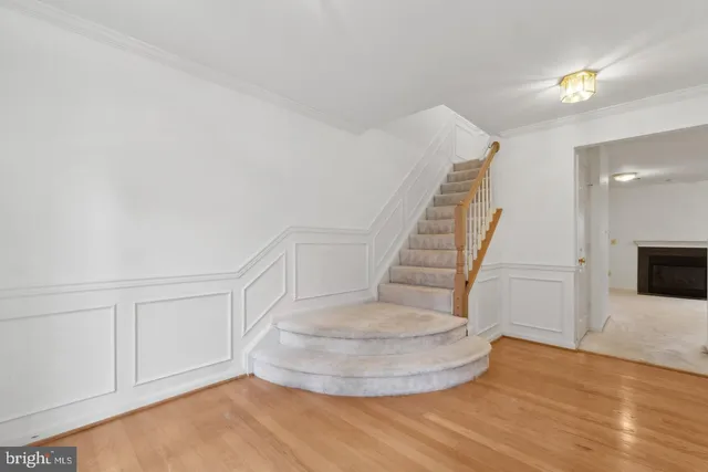a view of entryway and hall with wooden floor