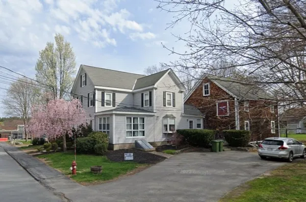 a view of multiple houses with a yard