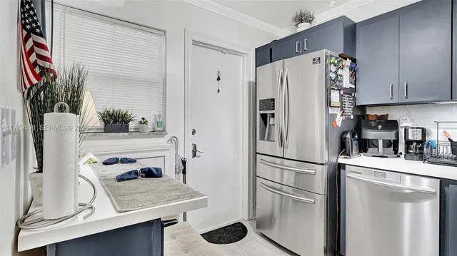 a kitchen with stainless steel appliances a refrigerator sink and stove