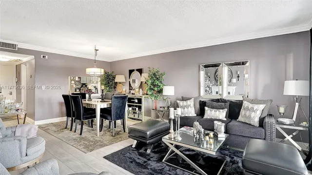 a living room with furniture and a dining table