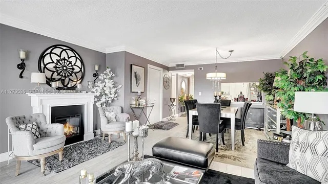 a living room with furniture a fireplace and a dining table with wooden floor