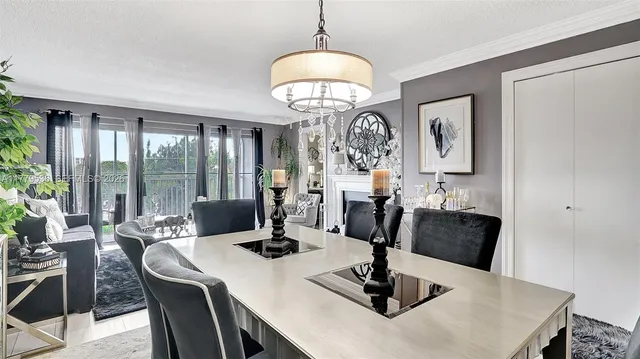 a dining room with furniture a chandelier and window