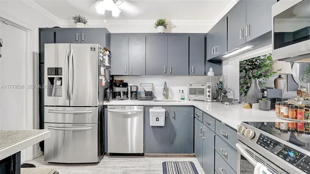 a kitchen with stainless steel appliances a refrigerator sink and cabinets