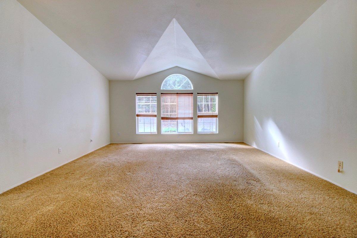 2101 Queens Branch Road Rogue River, OR 97537 - Photo 9 of 25 an empty room with windows and ceiling fan
