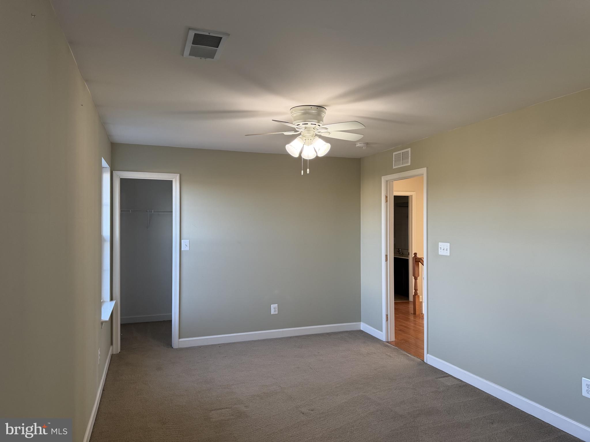 40 Loder Drive Smyrna, DE 19977 - Photo 19 of 29 an empty room with a chandelier fan and a window