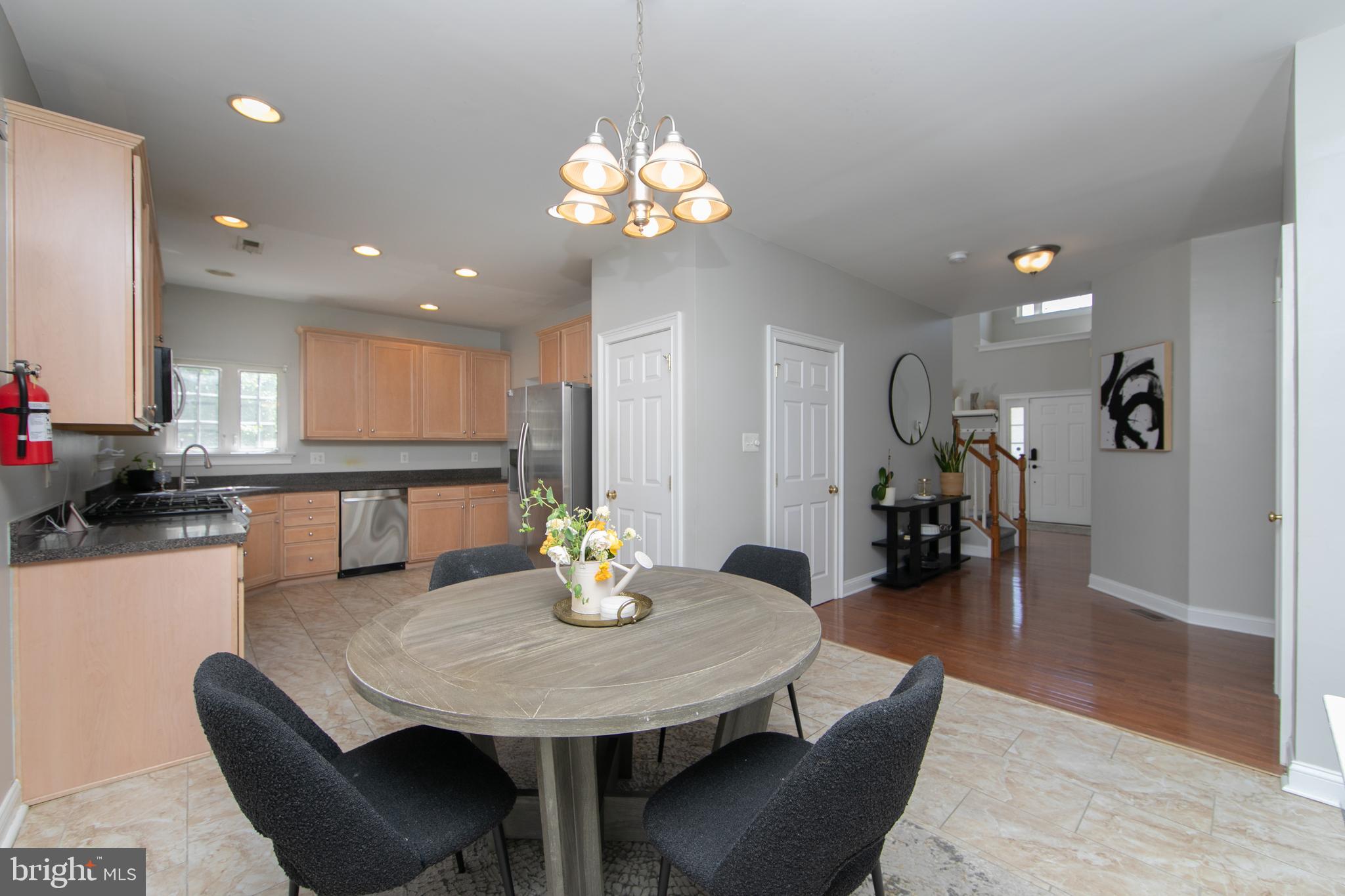 4 Conifer Way Sicklerville, NJ 08081 - Photo 12 of 39 a dining room with wooden floor a chandelier a glass table and chairs