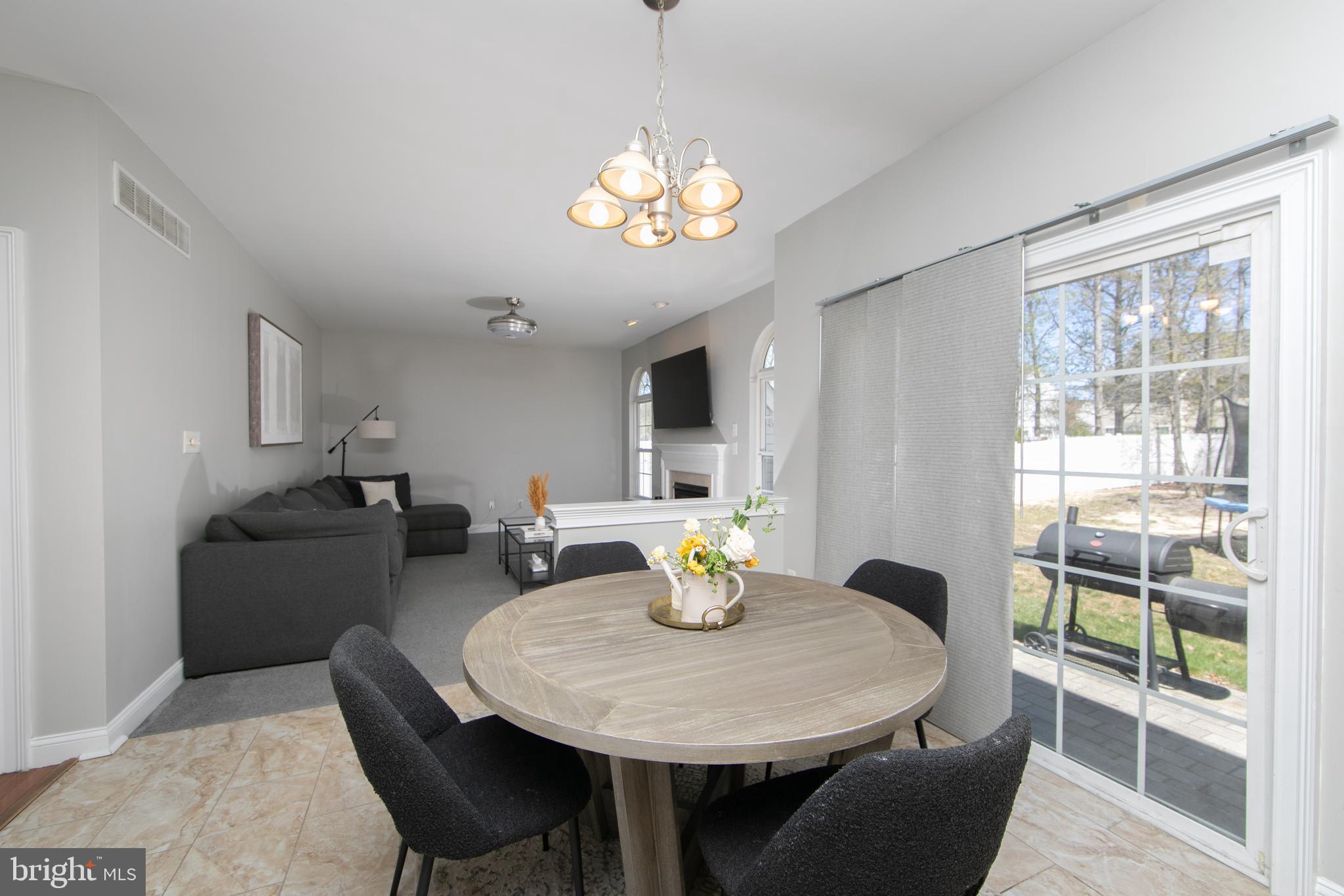 4 Conifer Way Sicklerville, NJ 08081 - Photo 13 of 39 a dining room with furniture a chandelier and wooden floor