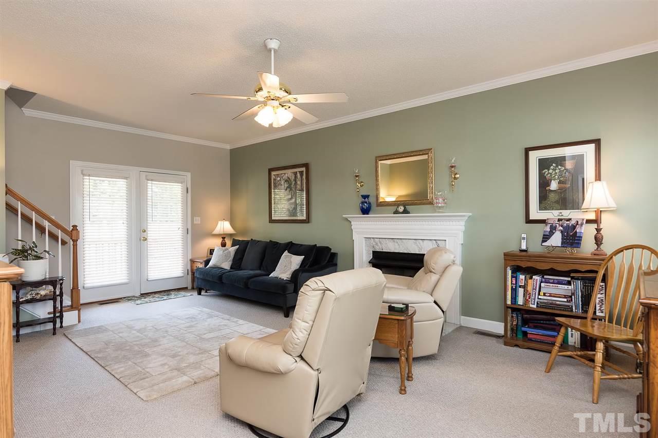 Wow, so many options for arranging your furniture! Gas log fireplace has a pretty white marble surround. Crown molding can be found in all rooms on the first floor.