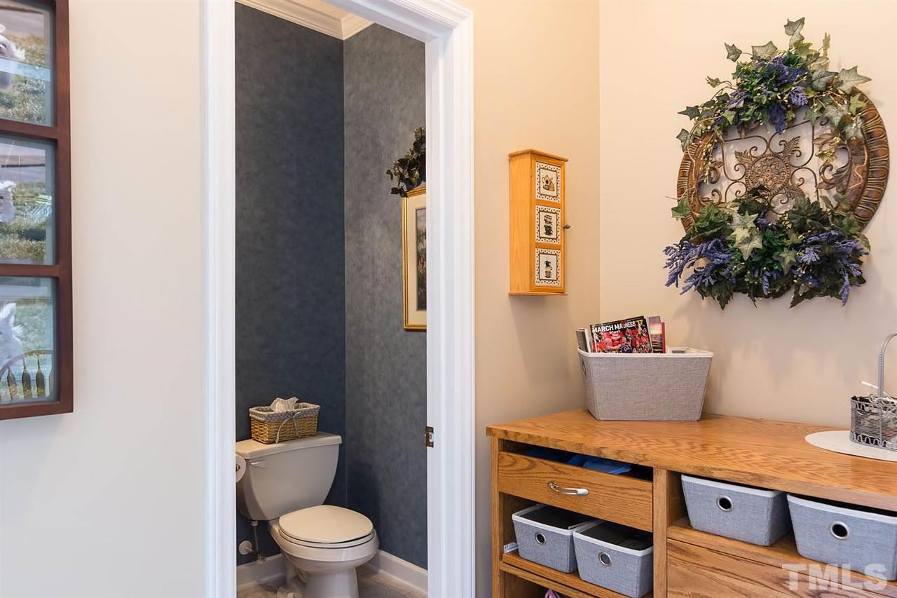 4401 Riverport Road Raleigh, NC 27616 - Photo 8 of 22 Powder room is located off of the kitchen and as soon as you come in from the garage.