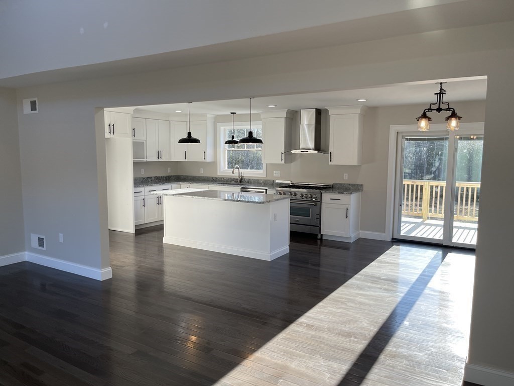 158 Snipatuit Road Rochester, MA 02770 - Photo 8 of 39 a kitchen with stainless steel appliances granite countertop a stove top oven a sink and white cabinets with wooden floor