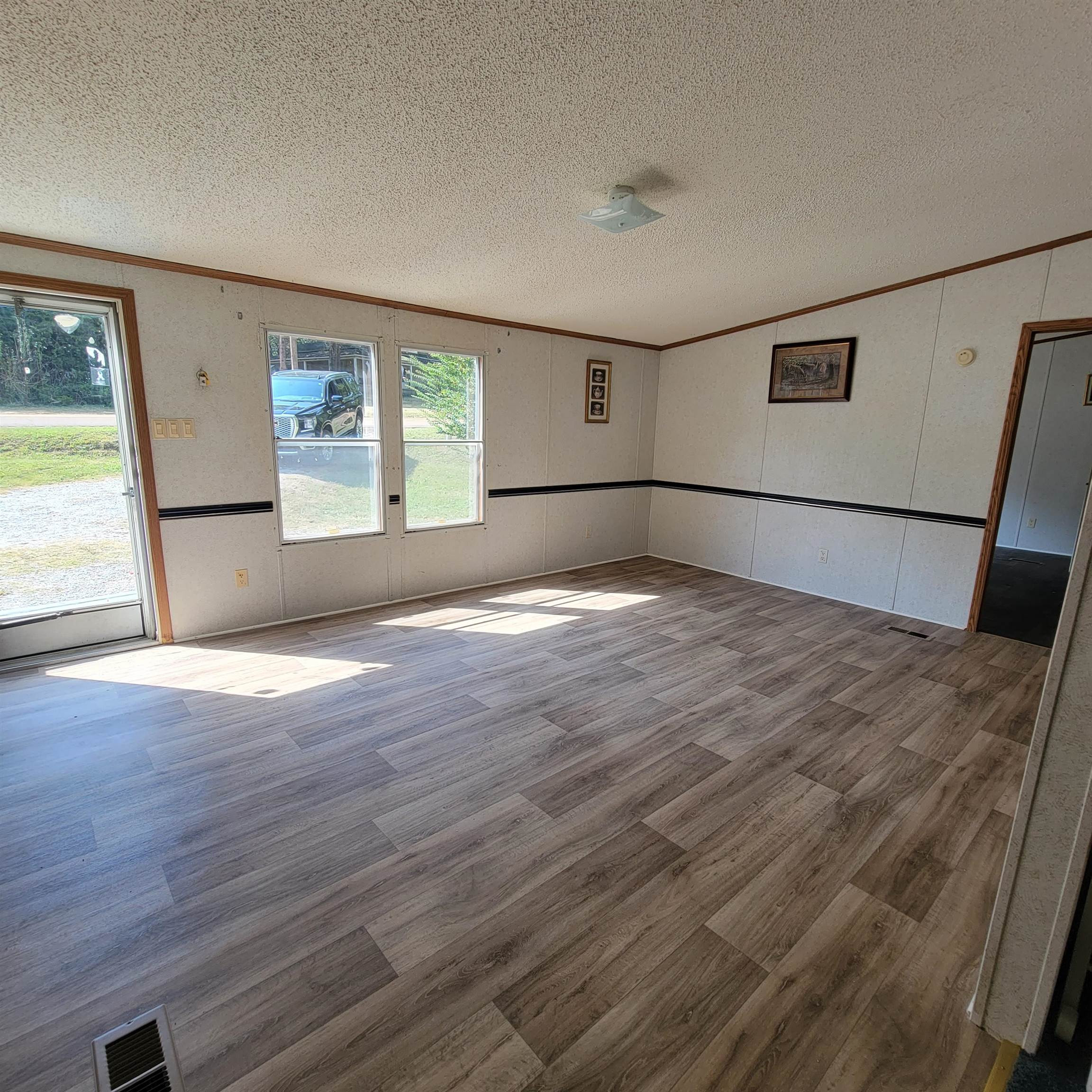 2012 Finger Leapwood Road Finger, TN 38334 - Photo 3 of 12 an empty room with wooden floor and windows