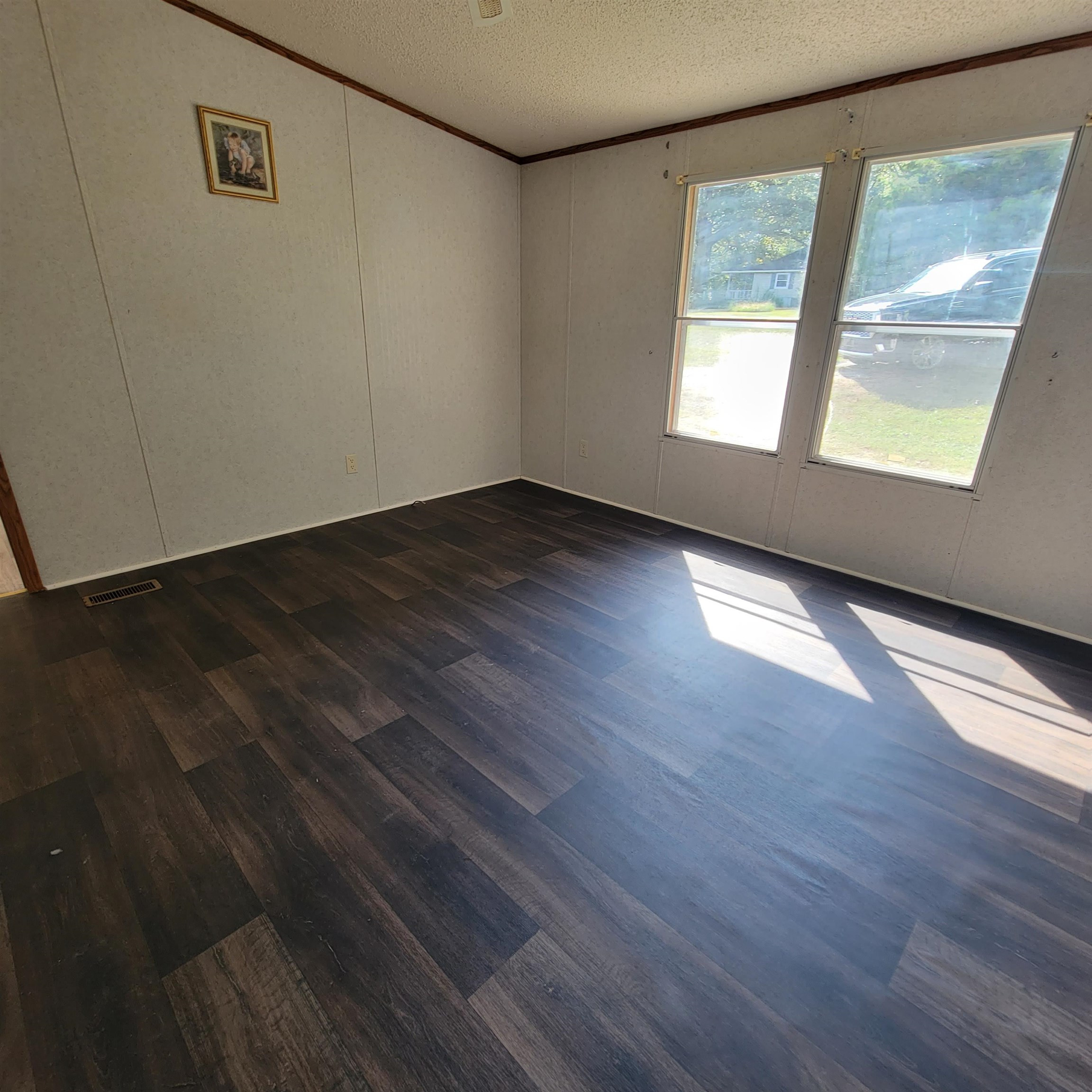 2012 Finger Leapwood Road Finger, TN 38334 - Photo 5 of 12 a view of an empty room with wooden floor and a window