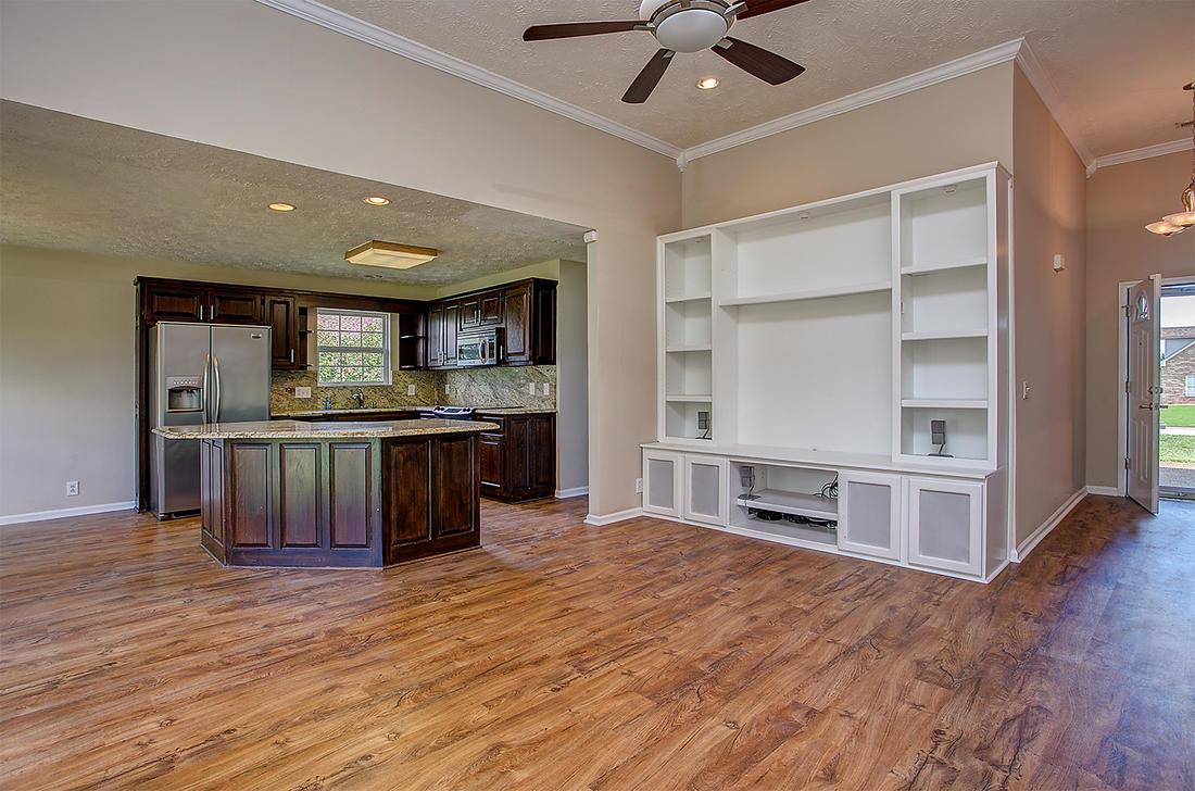 1228 Hunters Point Lane Spring Hill, TN 37174 - Photo 5 of 23 a kitchen with kitchen island a counter top a stove and a refrigerator