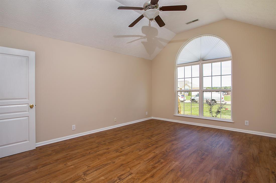 1228 Hunters Point Lane Spring Hill, TN 37174 - Photo 7 of 23 wooden floor in an empty room with a window