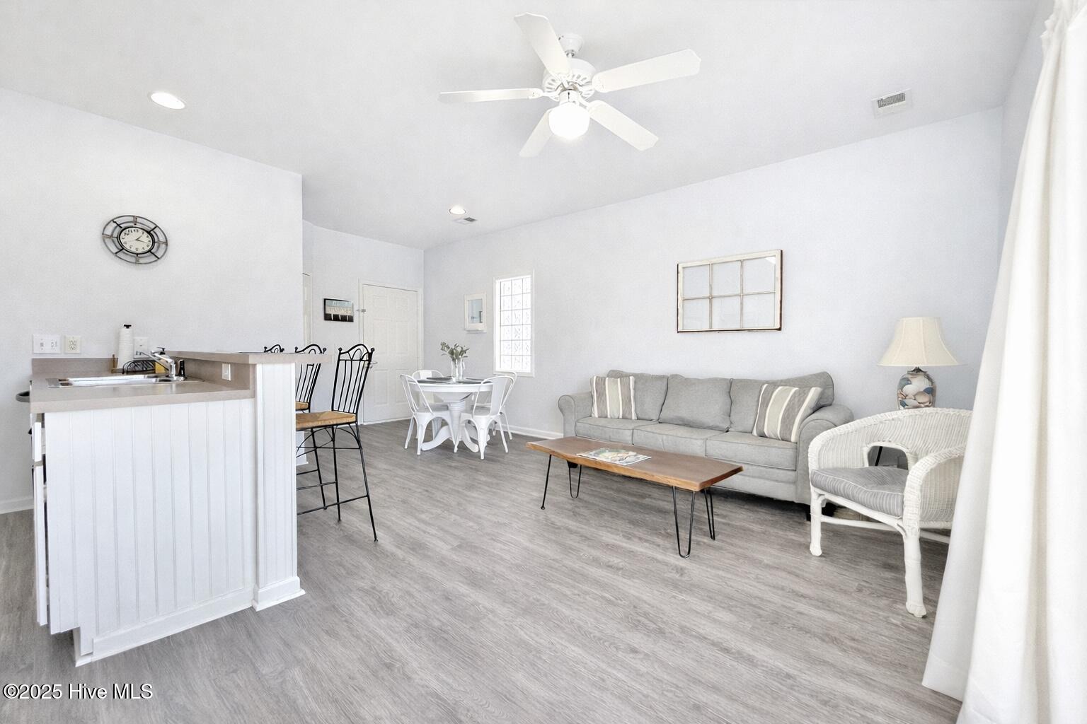 165 Royal Poste Road, Unit 2911 Sunset Beach, NC 28468 - Photo 4 of 24 Bright, open-concept living area with neutral finishes, luxury vinyl plank flooring, and abundant natural light.