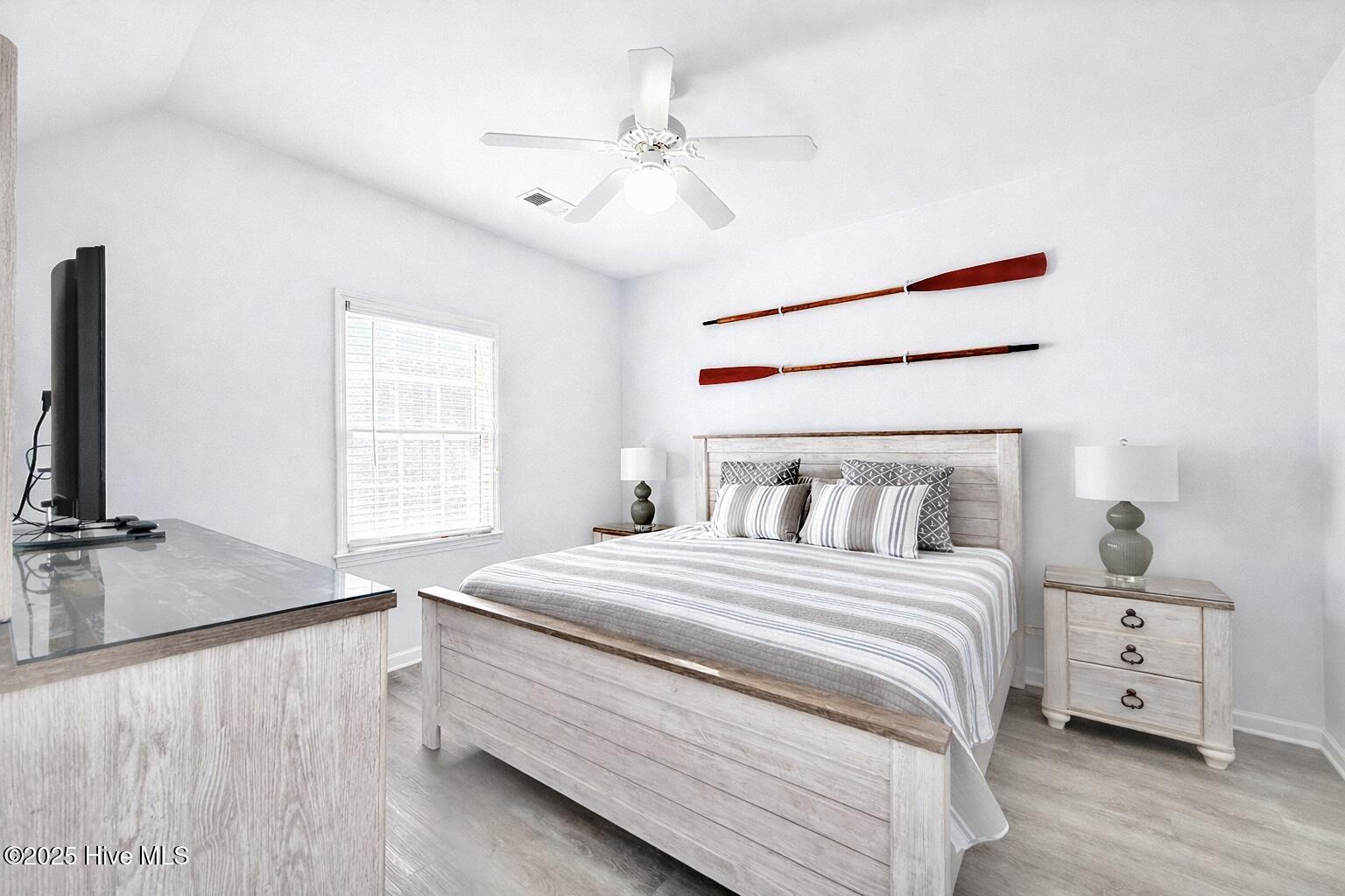 165 Royal Poste Road, Unit 2911 Sunset Beach, NC 28468 - Photo 7 of 24 Spacious primary bedroom featuring neutral décor, ceiling fan, and private access to ensuite bathroom.
