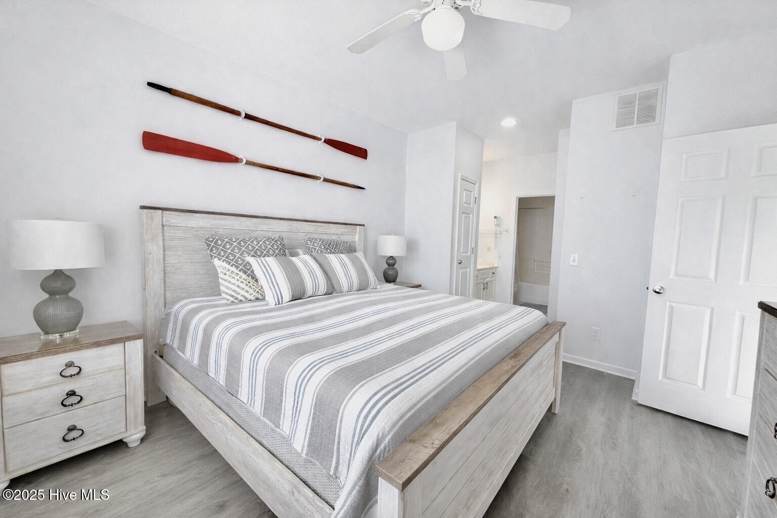 165 Royal Poste Road, Unit 2911 Sunset Beach, NC 28468 - Photo 8 of 24 Spacious primary bedroom featuring neutral décor, ceiling fan, and private access to ensuite bathroom.