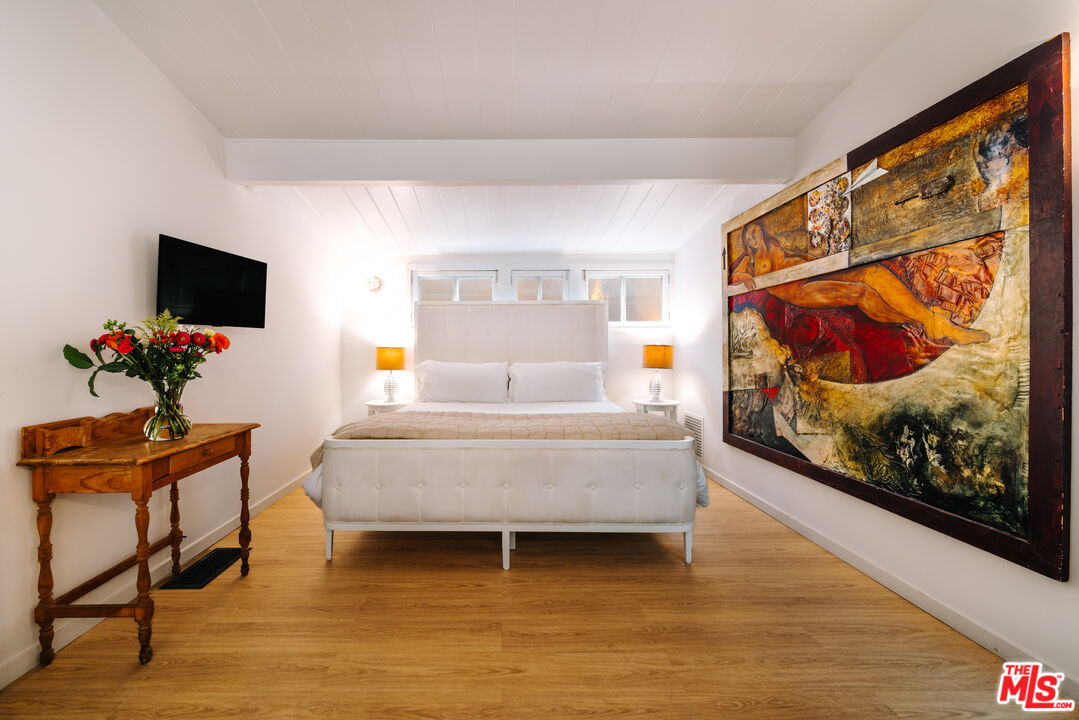 936 Palisades Beach Road Santa Monica, CA 90403 - Photo 12 of 31 a living room with furniture and a flat screen tv