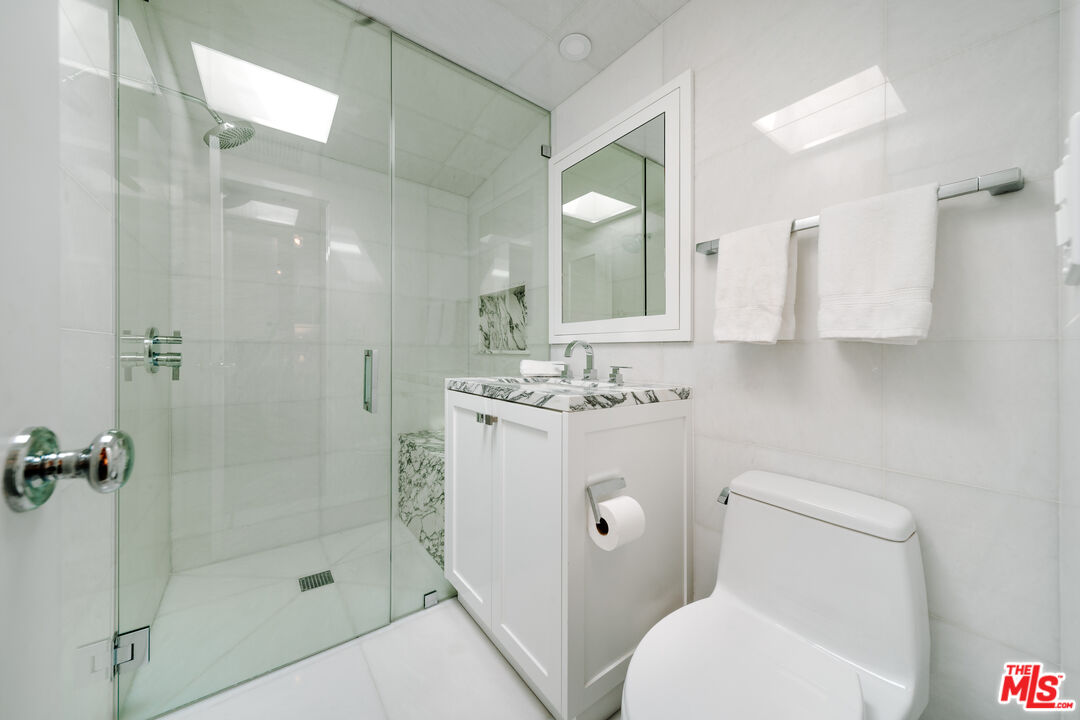 936 Palisades Beach Road Santa Monica, CA 90403 - Photo 13 of 31 a bathroom with a sink toilet and shower