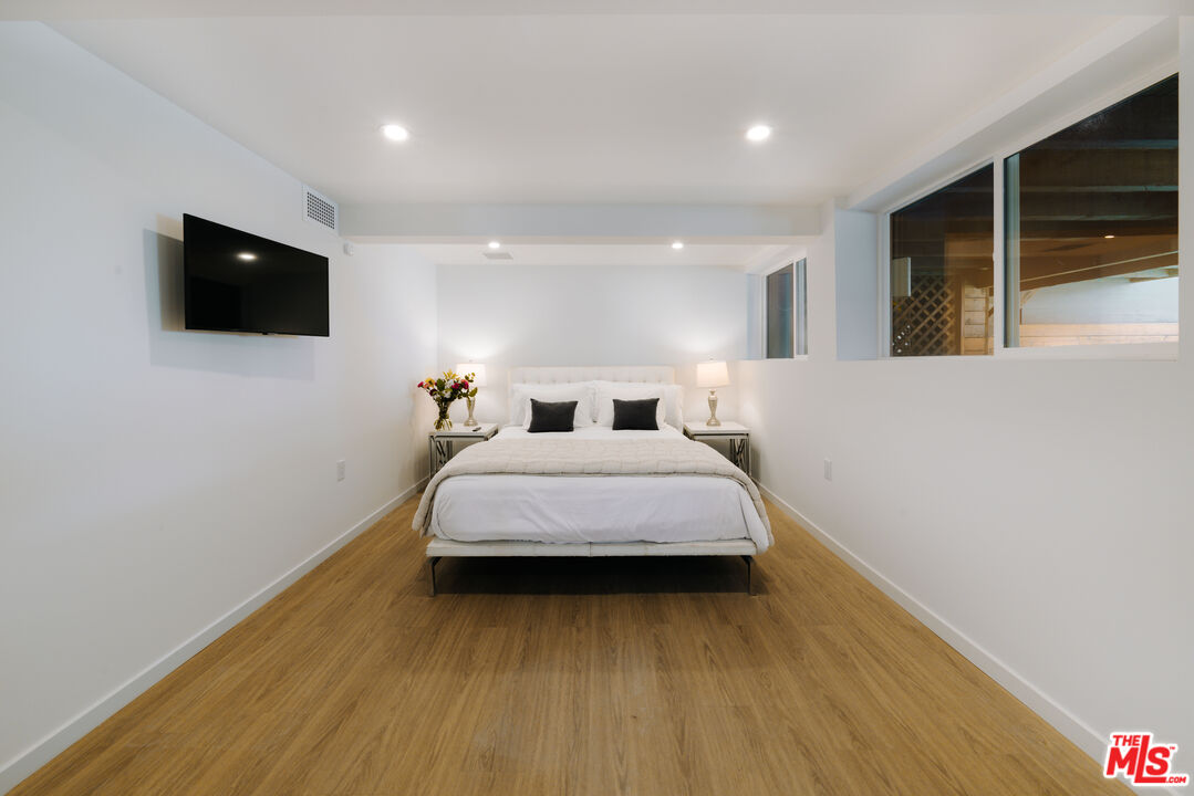 936 Palisades Beach Road Santa Monica, CA 90403 - Photo 15 of 31 a bedroom with a bed and a flat screen tv