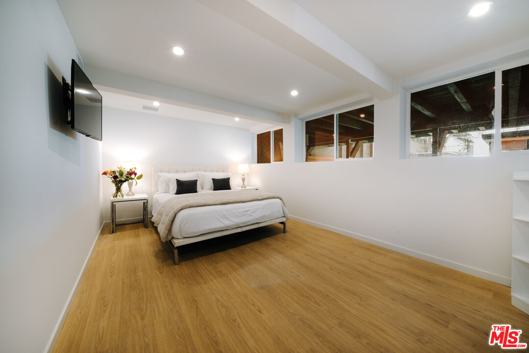 936 Palisades Beach Road Santa Monica, CA 90403 - Photo 16 of 31 a bedroom with a bed and a flat screen tv