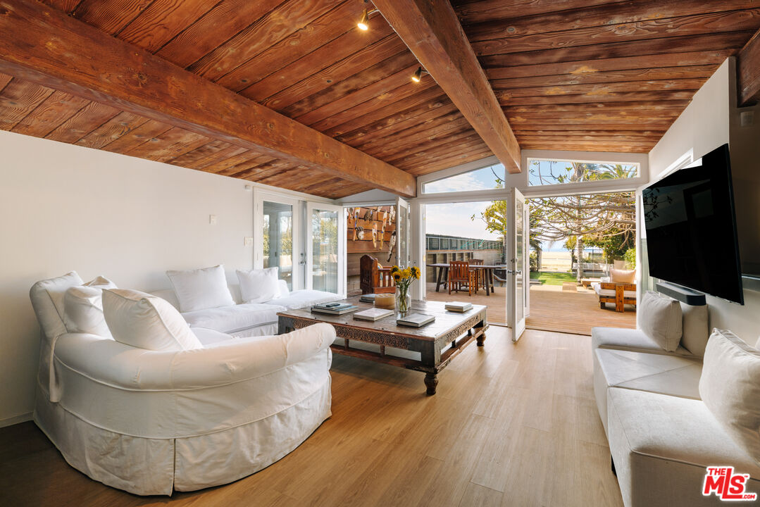 936 Palisades Beach Road Santa Monica, CA 90403 - Photo 2 of 31 a living room with furniture and a flat screen tv