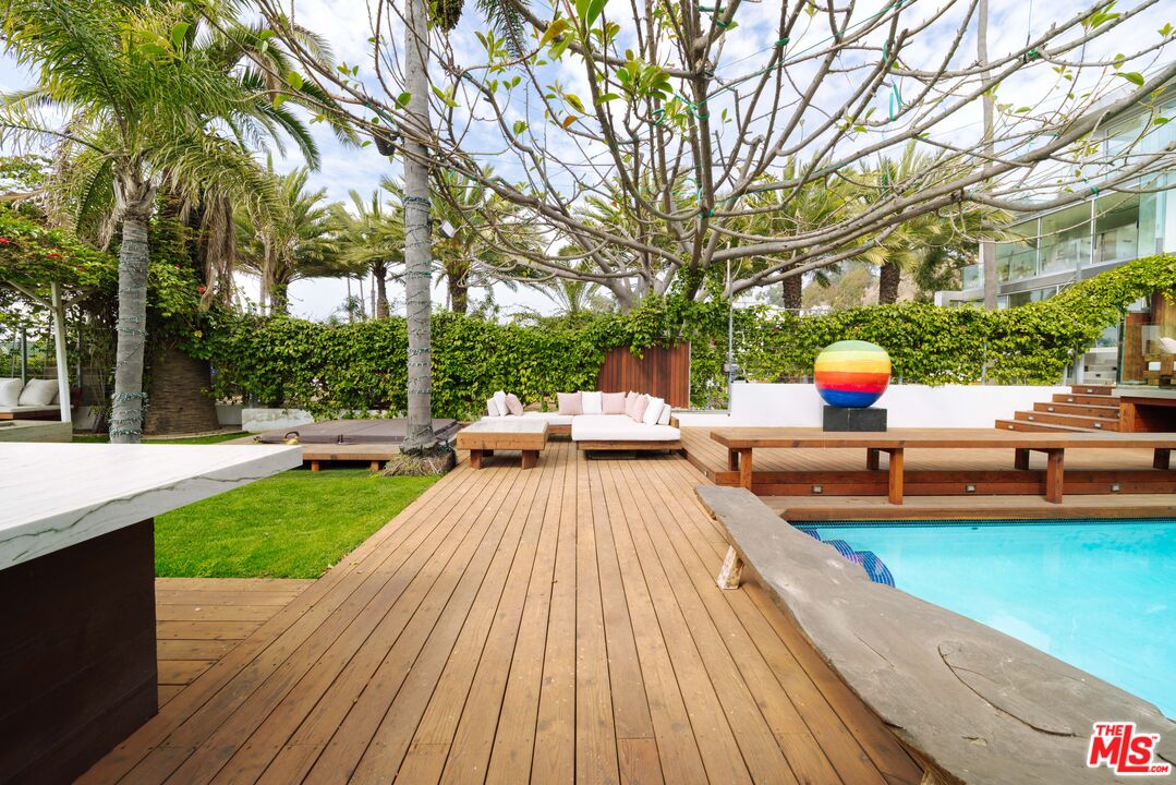 936 Palisades Beach Road Santa Monica, CA 90403 - Photo 24 of 31 a view of swimming pool with lounge chair and trees