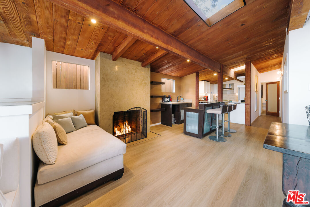 936 Palisades Beach Road Santa Monica, CA 90403 - Photo 3 of 31 a living room with furniture and a fireplace