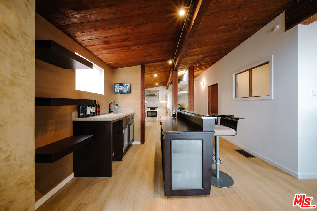 936 Palisades Beach Road Santa Monica, CA 90403 - Photo 5 of 31 a kitchen with stainless steel appliances granite countertop a sink a stove and a wooden floors