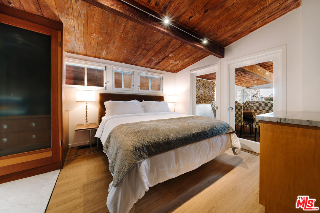 936 Palisades Beach Road Santa Monica, CA 90403 - Photo 8 of 31 a spacious bedroom with a bed and wooden floor