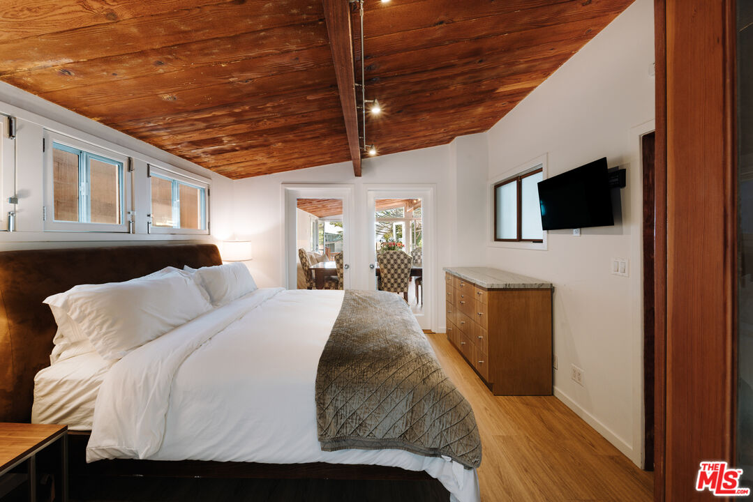 936 Palisades Beach Road Santa Monica, CA 90403 - Photo 9 of 31 a bed sitting in a bedroom next to a tv