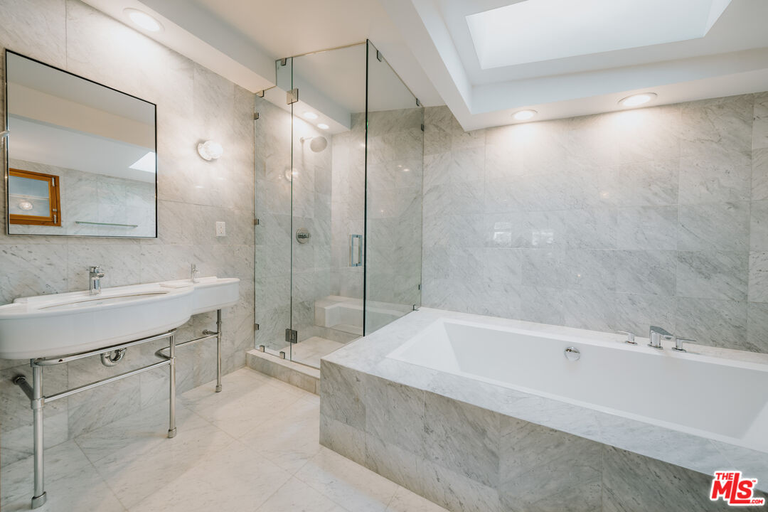 936 Palisades Beach Road Santa Monica, CA 90403 - Photo 10 of 31 a spacious bathroom with a tub sink shower and mirror