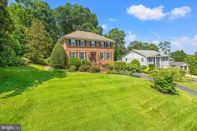 a view of a house with a big yard and potted plants