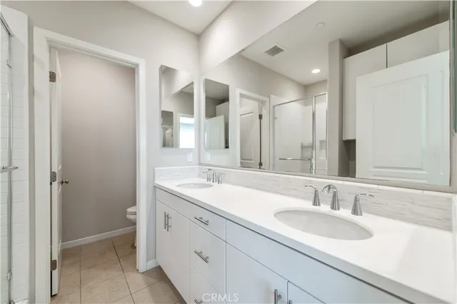 a bathroom with a double vanity sink mirror and double