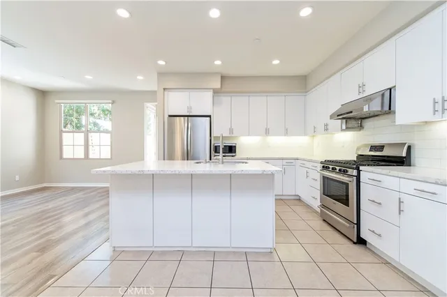 a kitchen with a sink window and cabinets