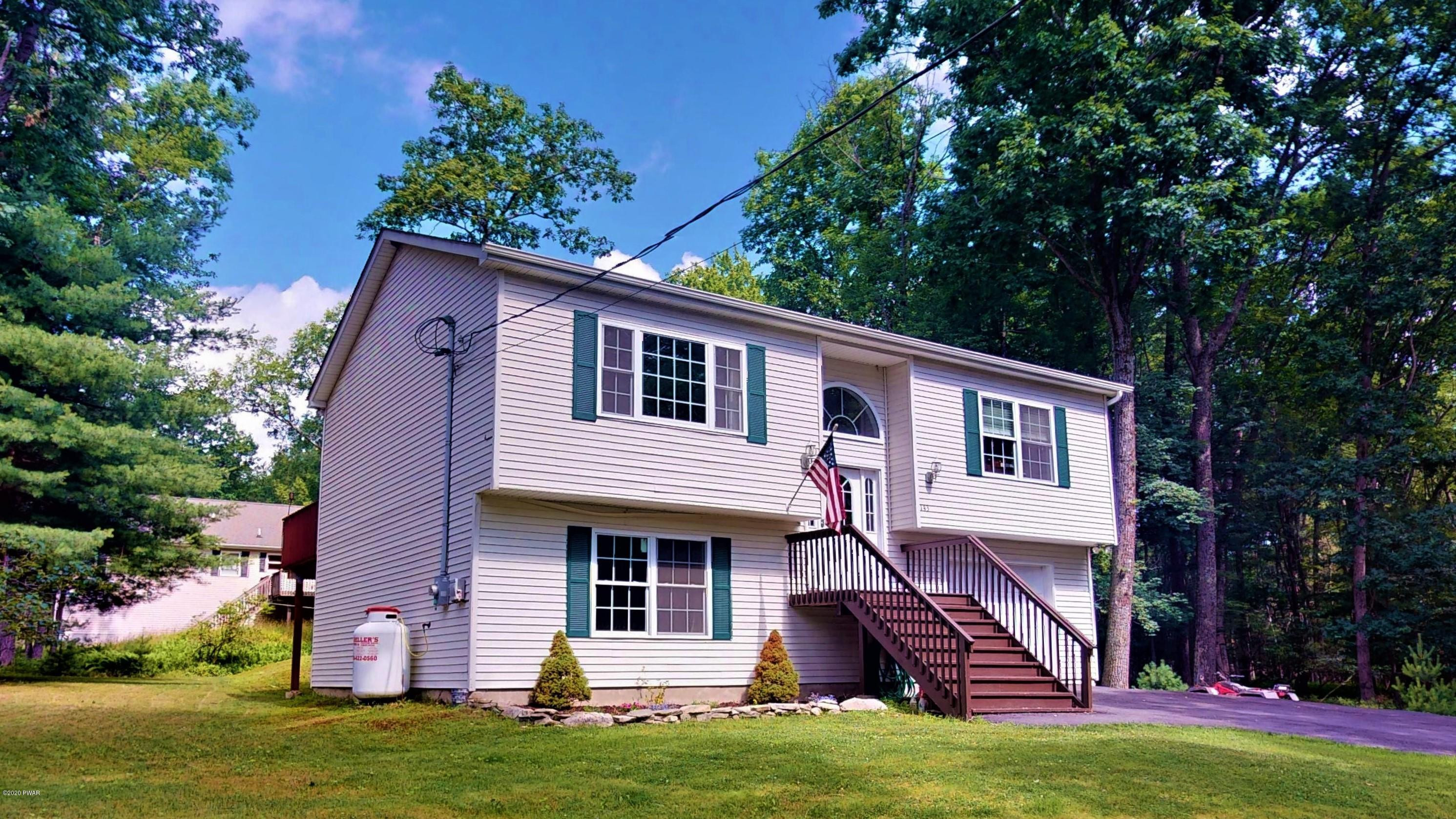a front view of a house with a garden