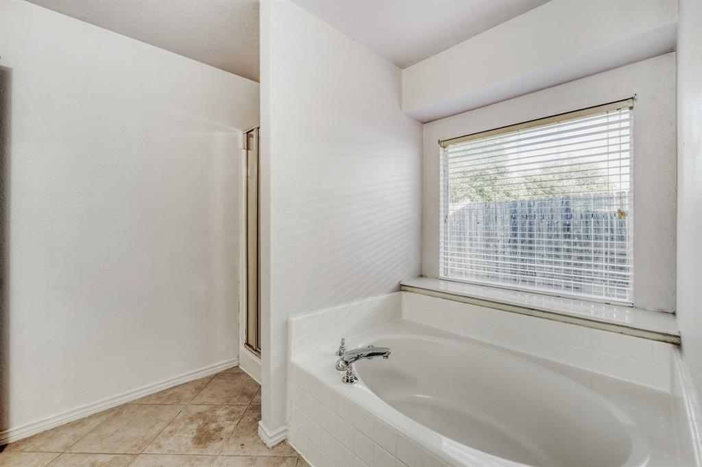 2617 Hereford Road Denton, TX 76210 - Photo 24 of 27 a white bath tub sitting next to a window
