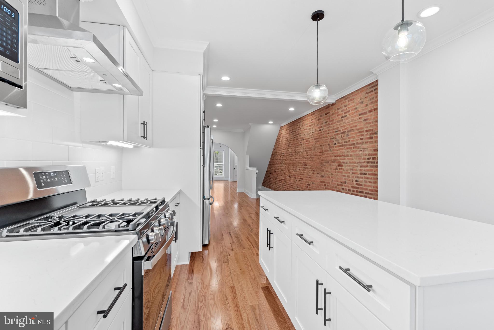 1434 Marshall Street Baltimore, MD 21230 - Photo 15 of 40 a kitchen with stove and cabinets