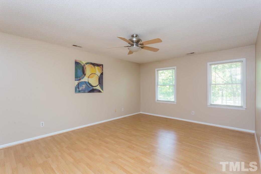 1117 Sedwick Road Durham, NC 27713 - Photo 8 of 13 an empty room with windows and fan
