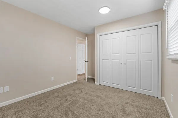 an empty room with closet area