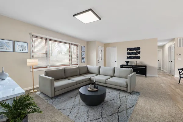 a living room with furniture and a large window