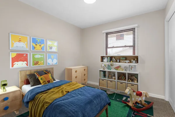 a bedroom with a bed and a window