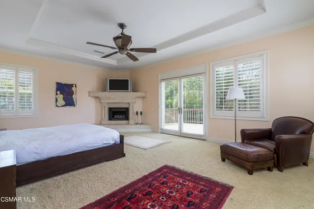 a bedroom with a bed couch and window